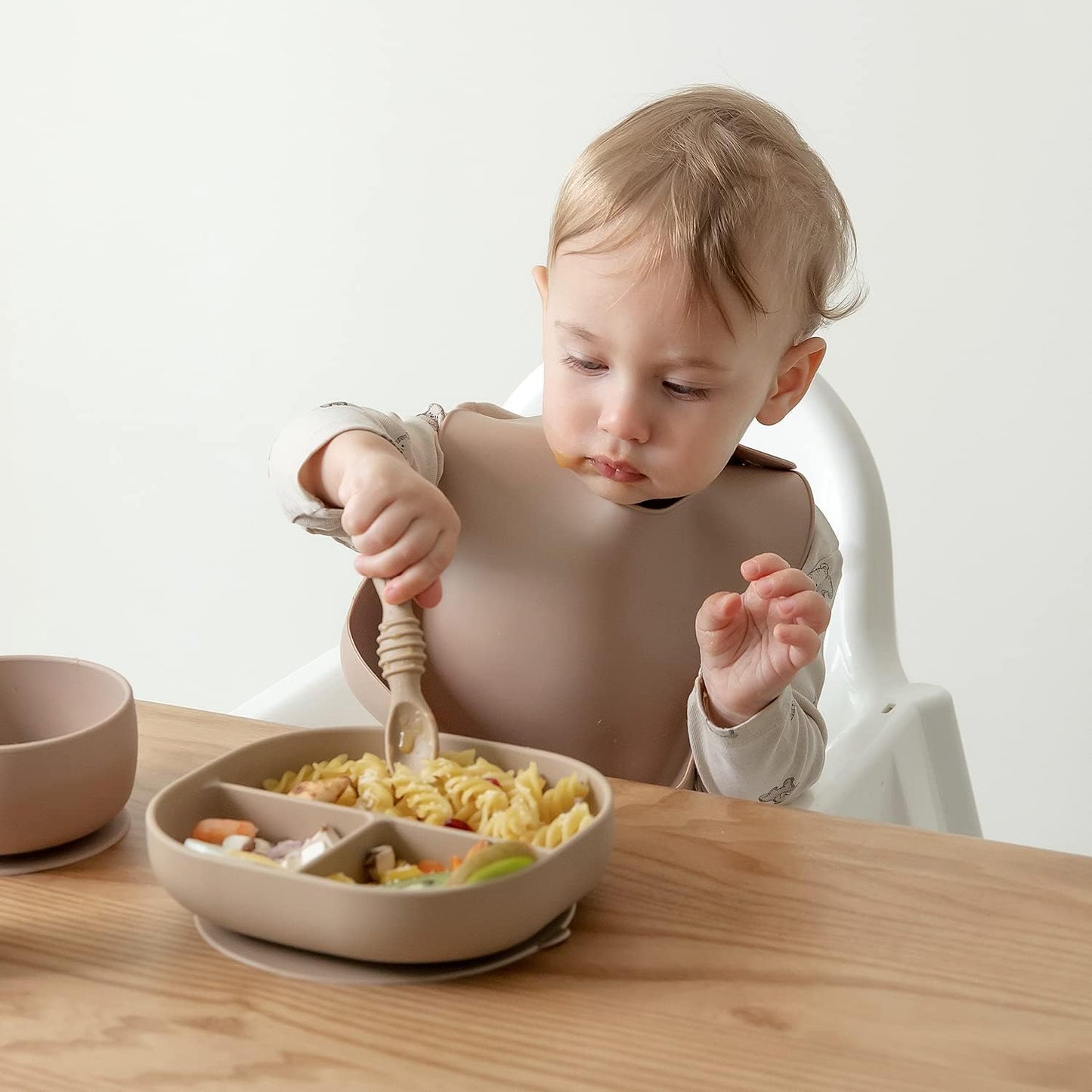 SAMiGO Silicone Baby Utensils - Self Feeding Spoons and Tiny Training Cup - First Stage Baby Led Weaning Supplies for 6 Months+ Infants - Set of 4